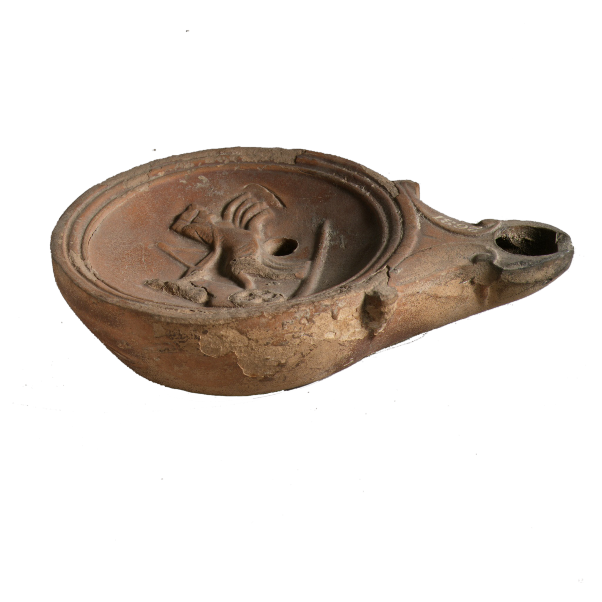 A ceramic oil lamp. It is round with a hole like a spout.
