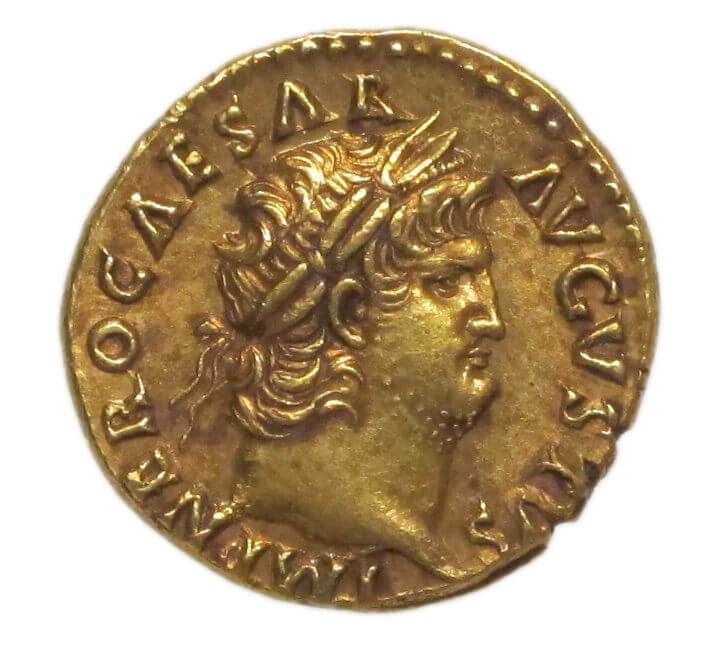 A gold coin with a profile of a man with a wide neck and a prominent chin. He has a garland around his head.