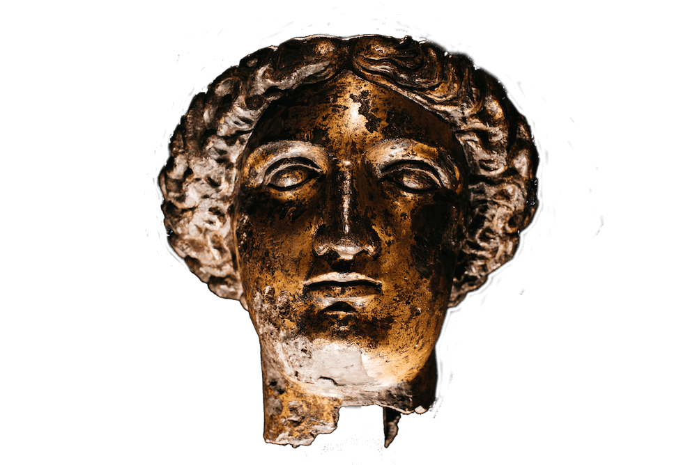 A bronze head of a woman. Her hair is arrnaged intricately around her face.