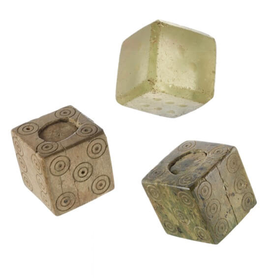 Three dice with numbers marked on their sides with small circles.