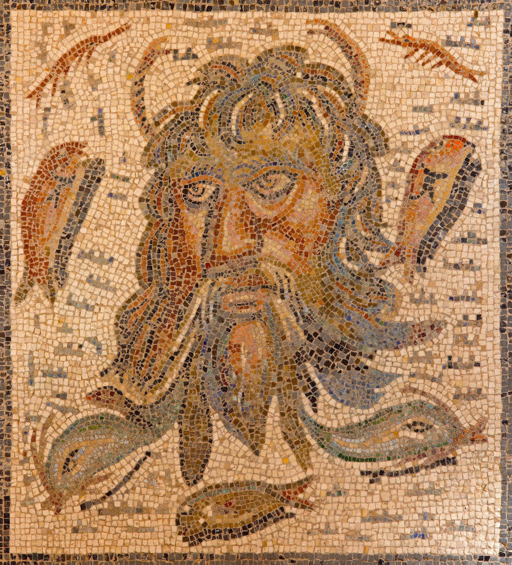 A mosaic showing the bearded head of Oceanus surrounded by sea creatures.