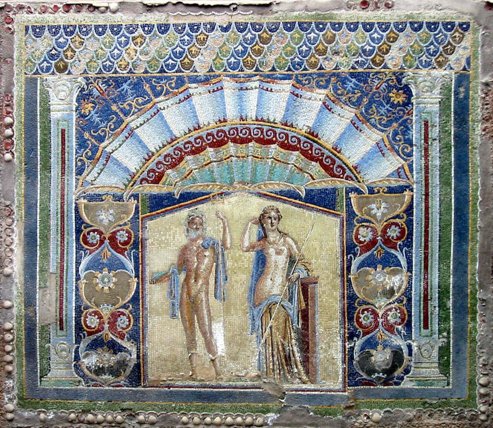 Mosaic showing a man and woman, both almost nude on a gold background. Above them is a pediment shaped and shaded like a scallop shell. The whole mosaic has veyr bright colours.