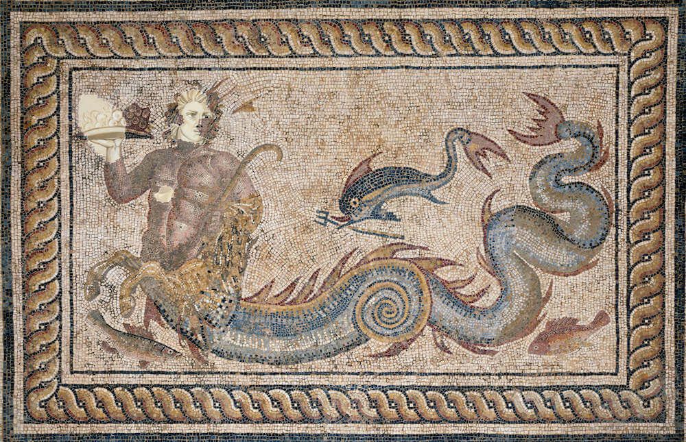 A mosaic of a serpent-tailed sea-god, with a dolphin carrying his trident. Parts of his face and right hand have been damaged and restored.