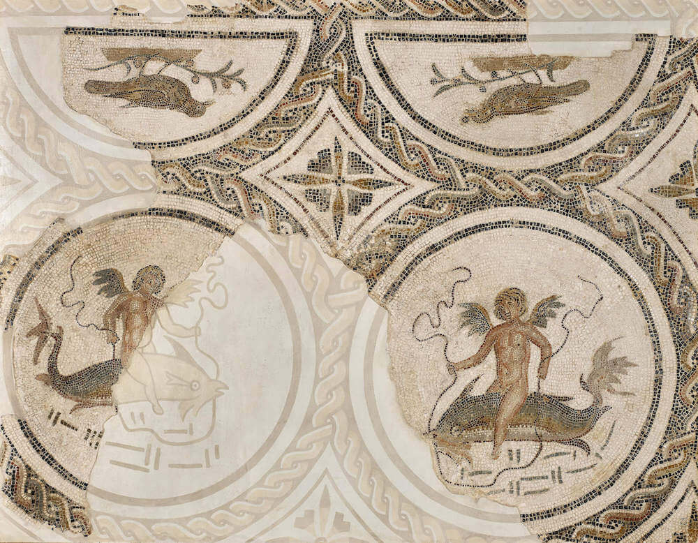 A mosaic with figures riding dolphins within an elaborate pattern of braided rings.