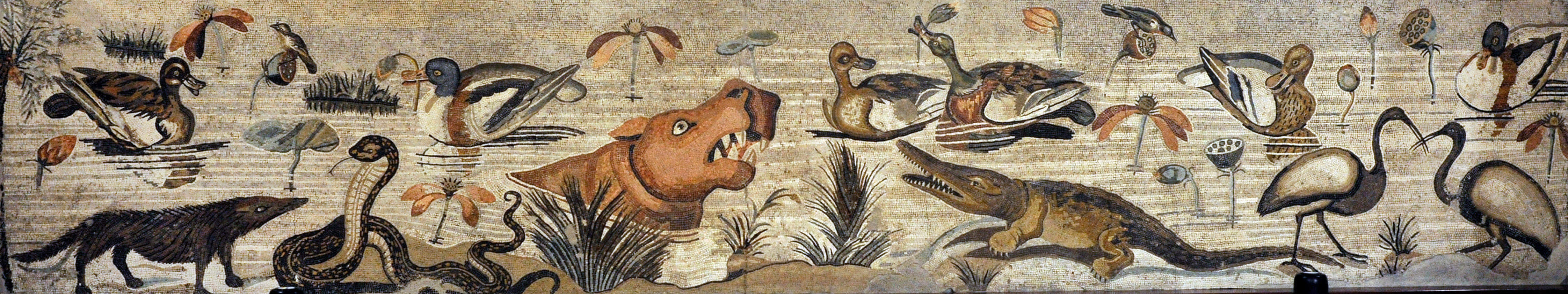 A mosaic illustrated with animals along the River Nile. There are ducks, snakes, and cranes, as well as smaller birds and insects. In the centre there is a crocodile and a hippopotamus.