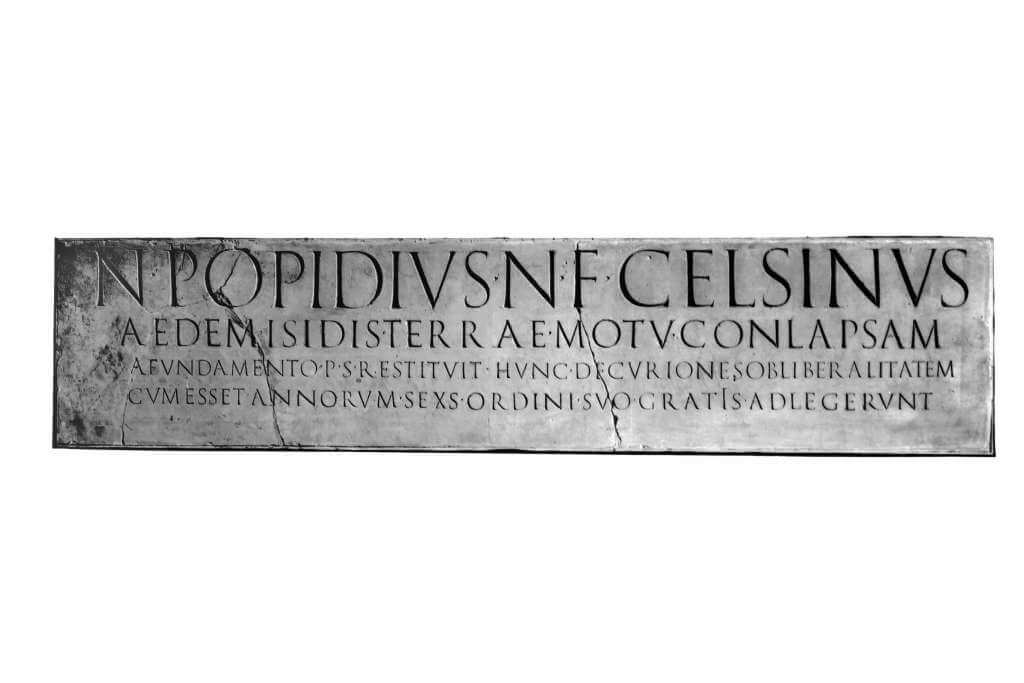 A wide, narrow piece of stone on which is carved Latin in very neat capital letters.