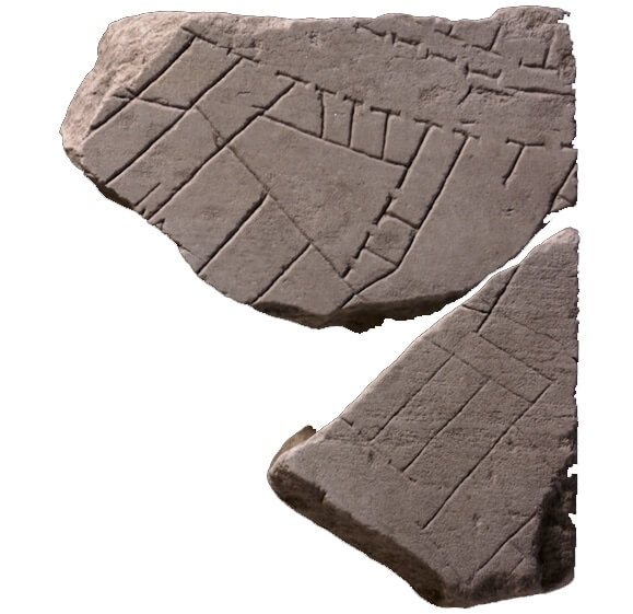 A broken stone fragment with markings on in little squares, lines, and dots.