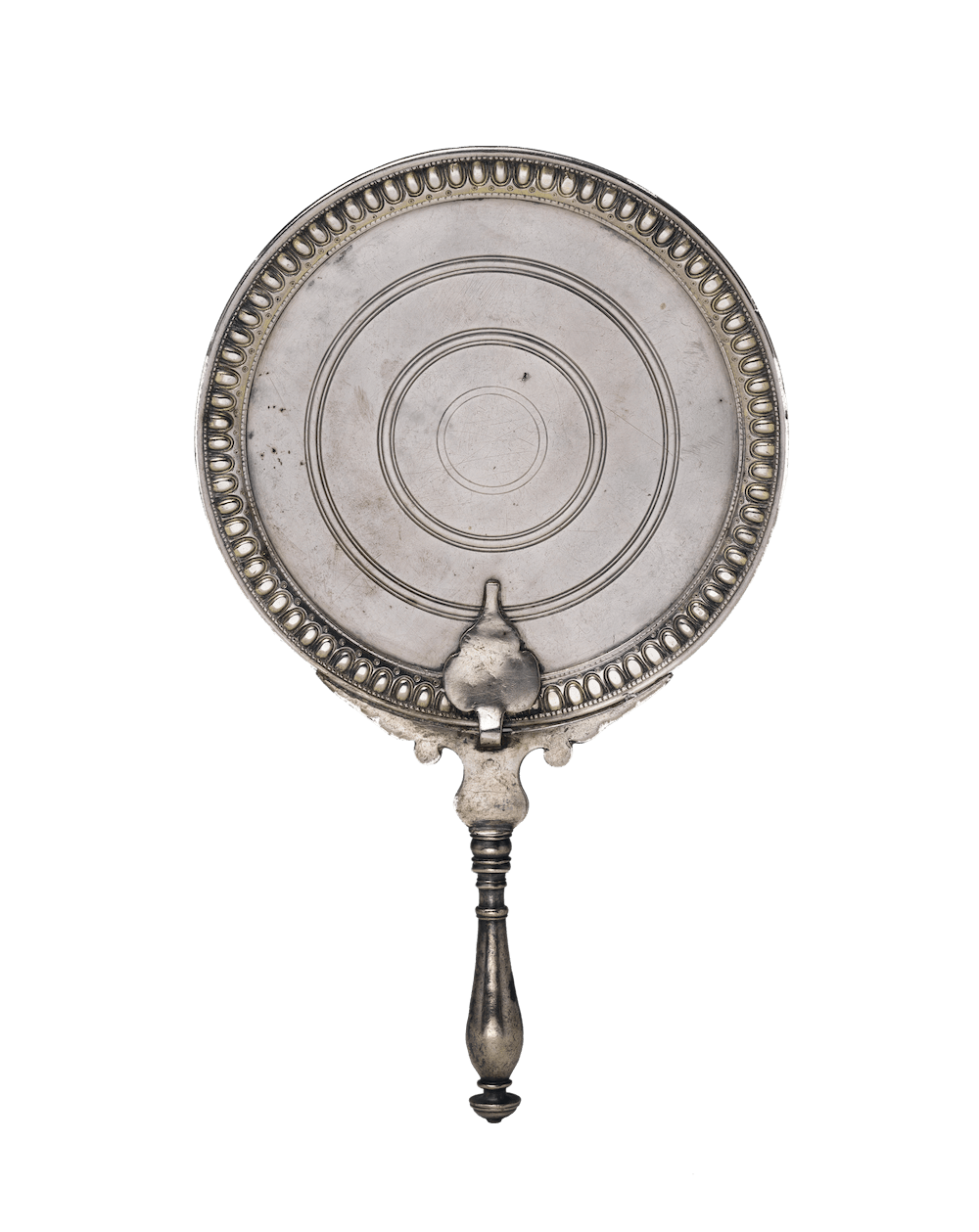 A handmirror with a narrow handle and a circular top.