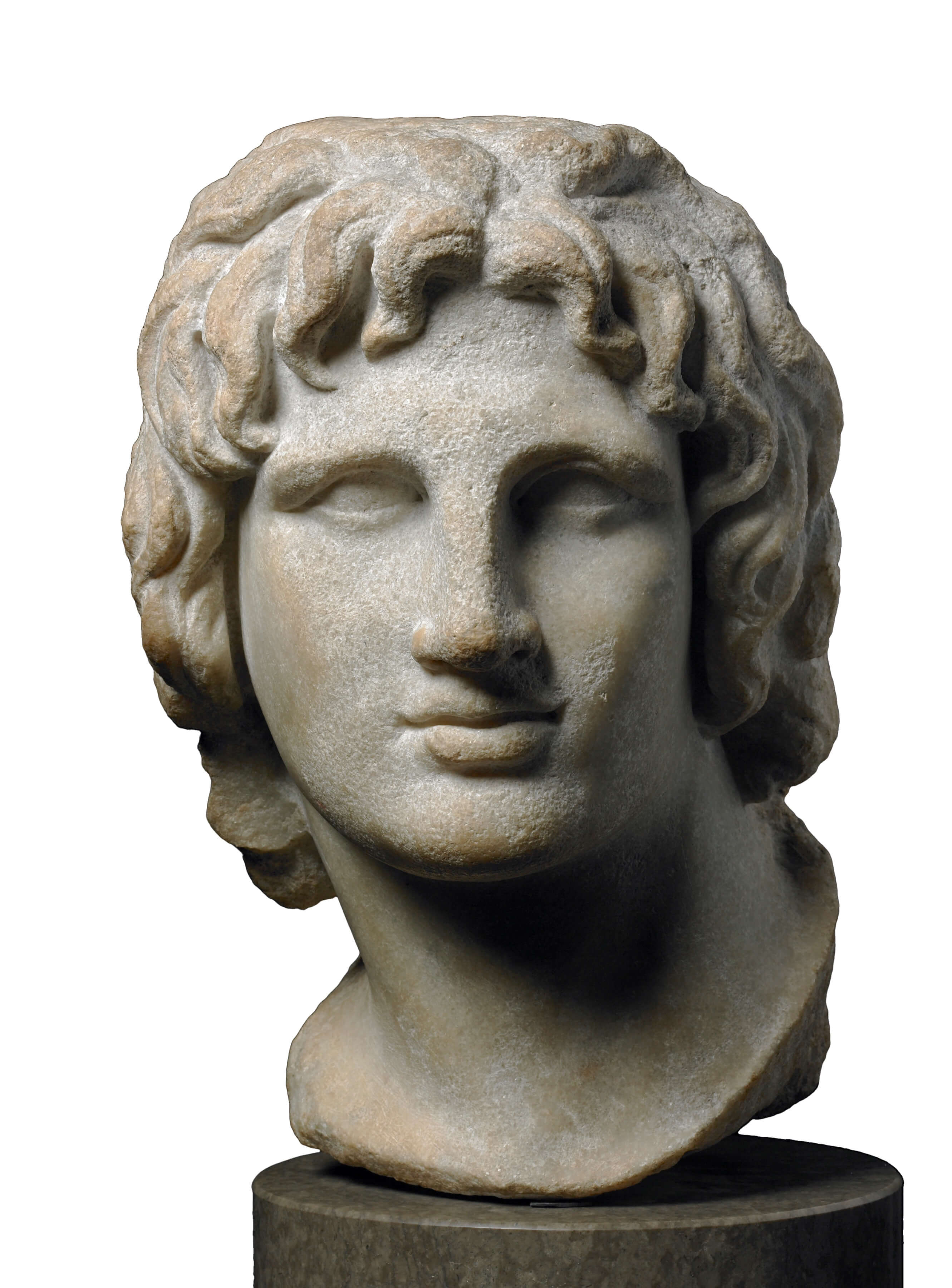 A carved marble head of a young man. It has been sligtly worn and smoothed by time. His hair falls in locks around his face and he has a long nose and full lips.