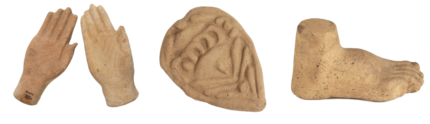 Three different votive offerings make of clay. The first is a pair of hands, the second the inner organs in a leaf shape, and the third a single foot up to the ankle.