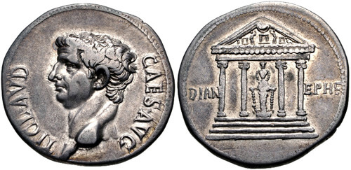 Two sides of a silver coin. One side shows the side portrait of a man. The other side shows a Greek-style temple. Inside the temple is the large figure of the cult statue. On either side of the temple are the letters DIAN EPHE.