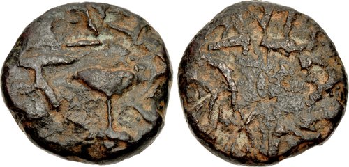 Two sides of a dark metal coin. it is a rough circular shape and has rough markings imprinted on both sides.