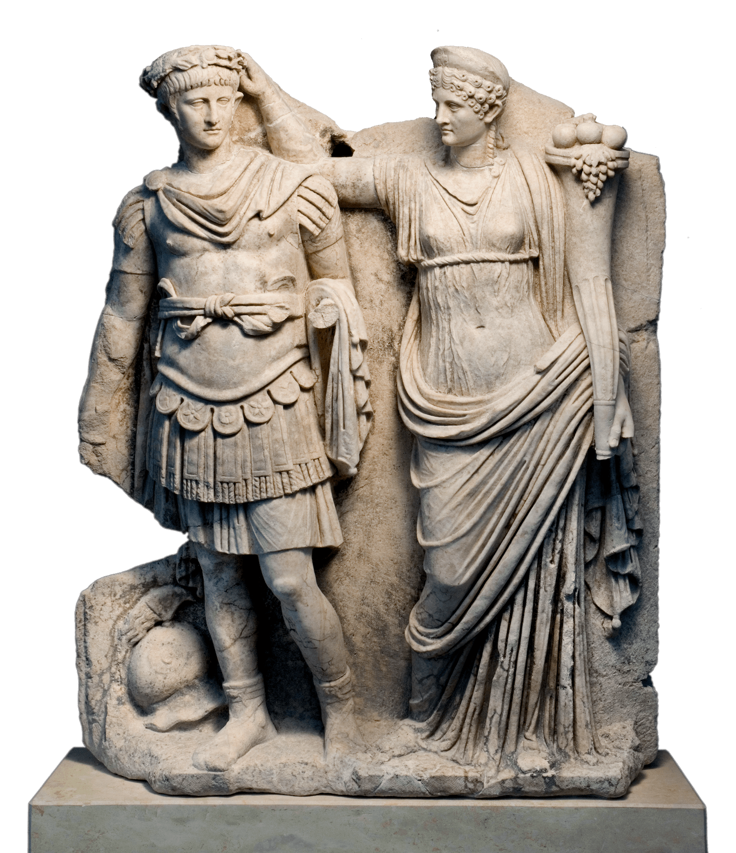 A stone relief showing a man on the left wearing armour. he is being crowned with a laurel wreath by a woman who stands to his left. In her other hand she is holding a cornucopia, the horn of plenty, from which a bunch of grapes and other fruits is visible.