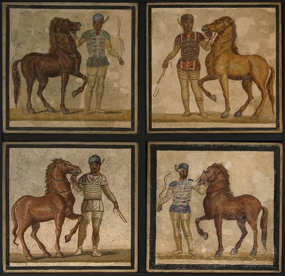 A mosaics divided into four parts. In each part is a charioteer with a different colour top standing next to a horse.
