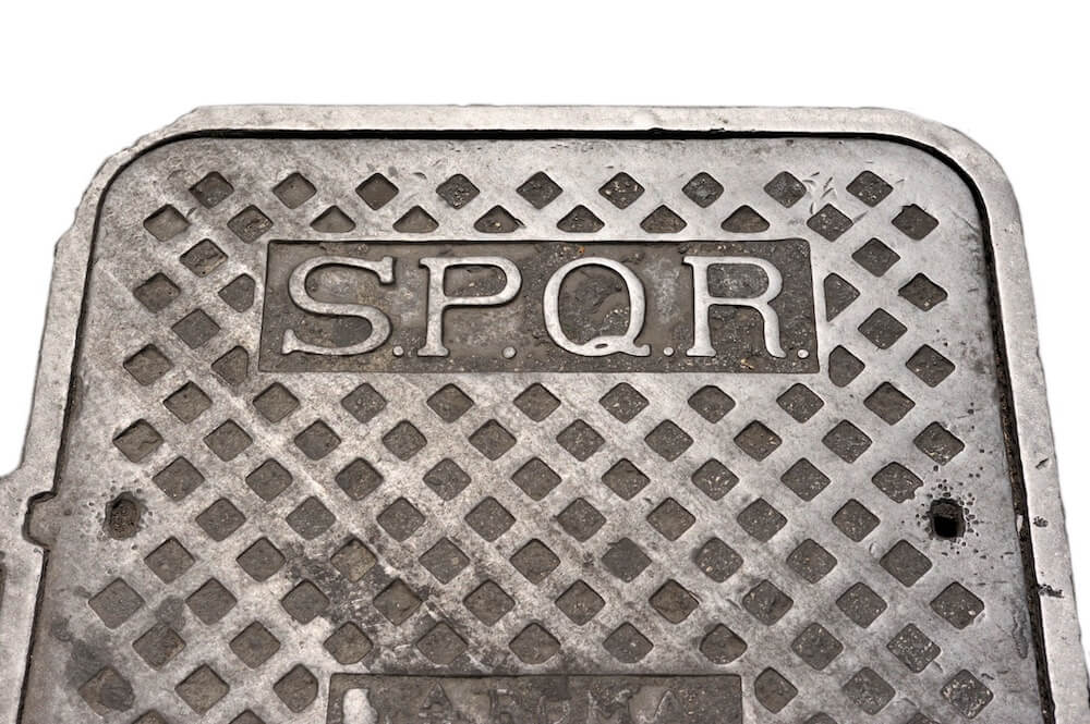 A modern draincover with the letters SPQR on the top.