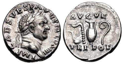 Two sides of a silver coin. One side shows the side profile of a man with a hooked nose who has a laurel wreath on this head. The other side has various objects in a row: a ladle, a ridged stick, a jug, and a stick with a curled end.