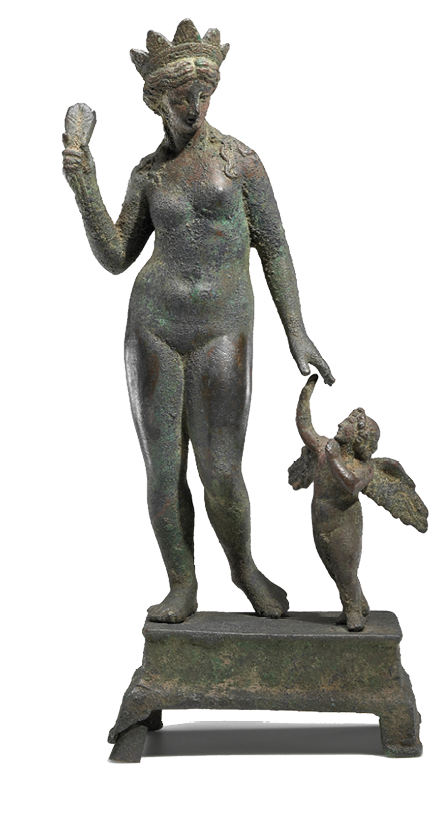 A bronze statuette showing a nude woman with a crown holding something in her right hand. On her left side stands a small child with wings.