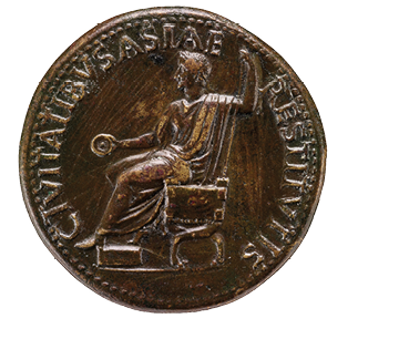 A bronze coin with a man shown side on sitting on a chair. Around the edge are words written in capital letters.