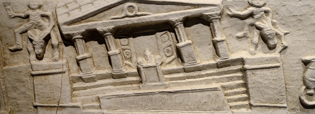 A carved stone relief showing a temple with four columns and steps, with an altar at the front. It is leaning to the left at a slight angle.