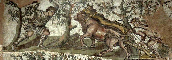 On the left of this mosaic a man wearing a long-sleeved tunic raises a stick in his hands. On the right another man pushes a plow, drawn by two oxen. Behind the figures are trees bearing fruit.