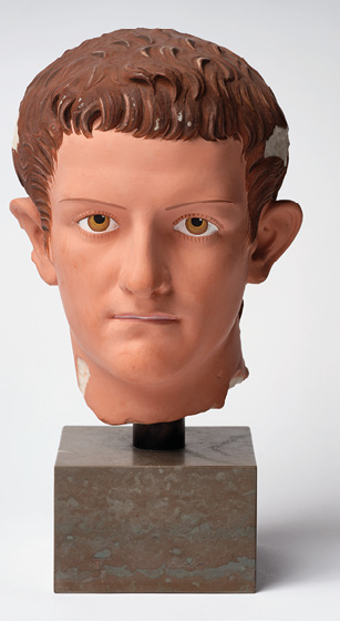 The same portrait of a young man painted in realistic colors. He has brown hair and hazel eyes.