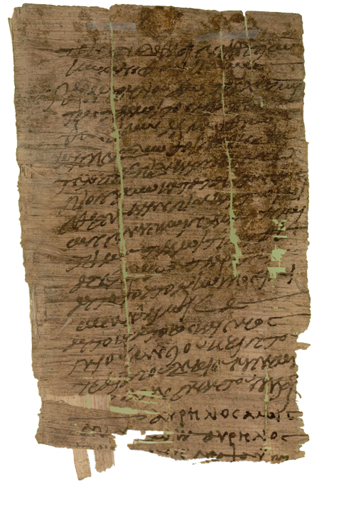 A scrap of dark parchment on which is written illegible text in black.