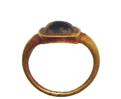 An old ring with a simple dark stone set into it.