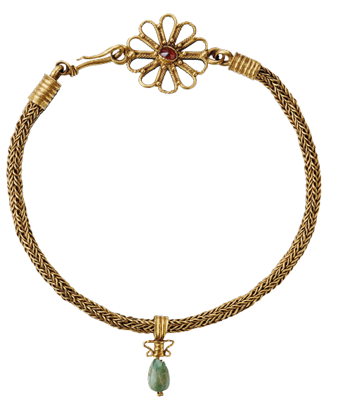 A circular necklace with a flower-shaped clasp. The main chain of the necklace is thick and gold and from the center hangs a small green stone.