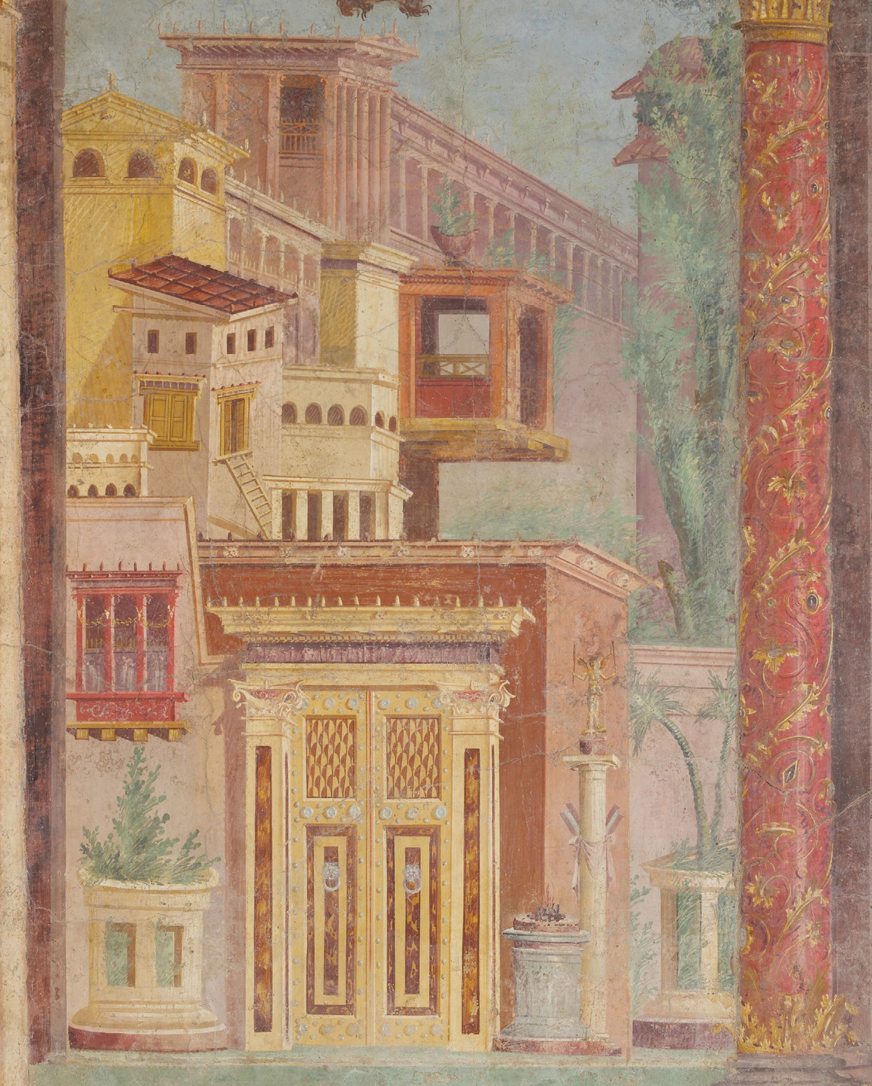 A wall painting showing an urban landscape of buildings. The architecture is busy with doors, windows, pillars, and balconies. The colors are mostly shades of red and orange.