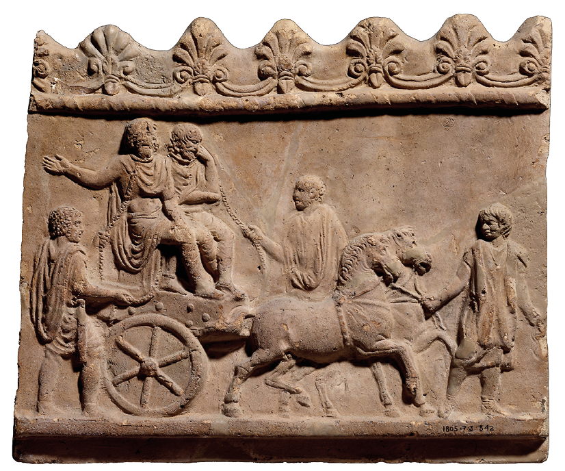 A rectangular piece of baked clay on with figures carved in relief. On it two prisoners in chains sit on a horse drawn cart, led by three other men. Along the top is a simple decorative border and a wavy edge.