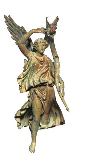 A metal figurine of a woman wearing a loose, flowing dress. The woman has wings and one leg is extended as if she is reaching down to land on the ground. She is carrying a long horn which reaches above her head.