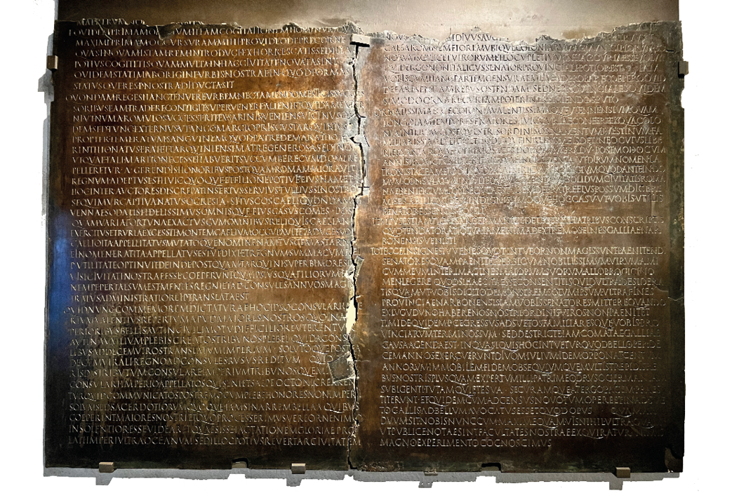 Two sheets of metal inscribed with small text. The central division is ragged and the top edge of the panels are missing.