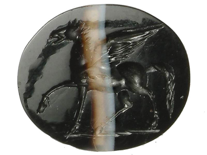 A black intaglio (seal-ring) showing an artfully carved Pegasus, its head held high.
