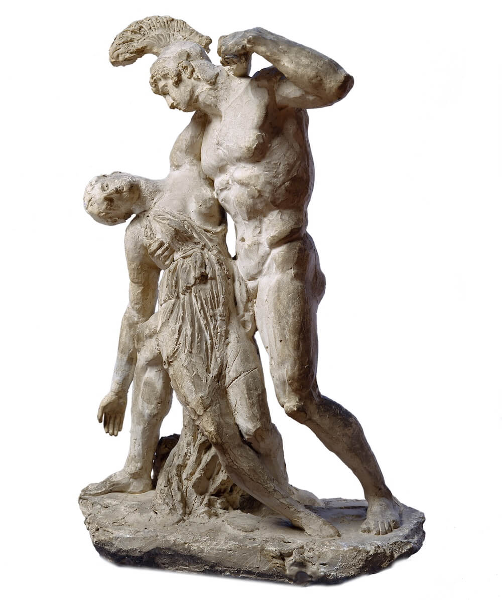 A statue of a man supporting a woman on his shoulder while she falls to the ground. The man is nude apart from a helmet, and the woman wears a long dress.