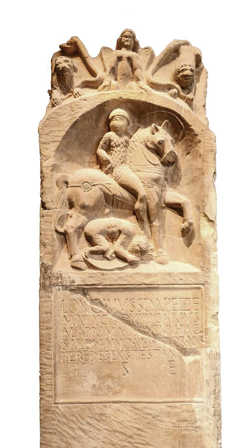 The cracked and worn tombstone of a Roman officer. It bears an inscription in capitals below a carving of the man himself, seated on a horse and trampling a hunched enemy.