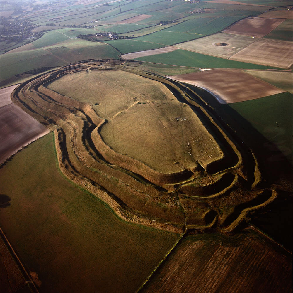 An aerial view of a hill with ledges and plateaus running around.