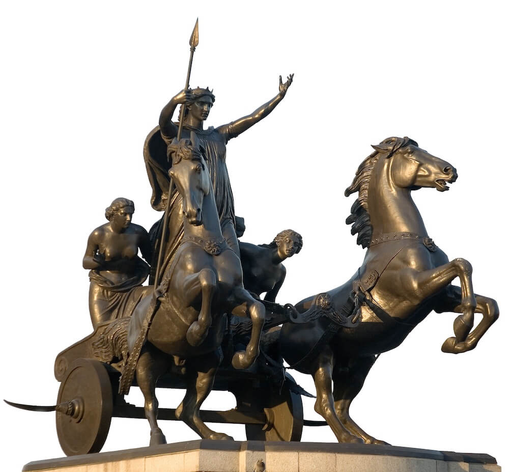 A bronze statue of Boudica riding in a chariot with her two daughters. She has her arms raised above her head and is holding a spear.