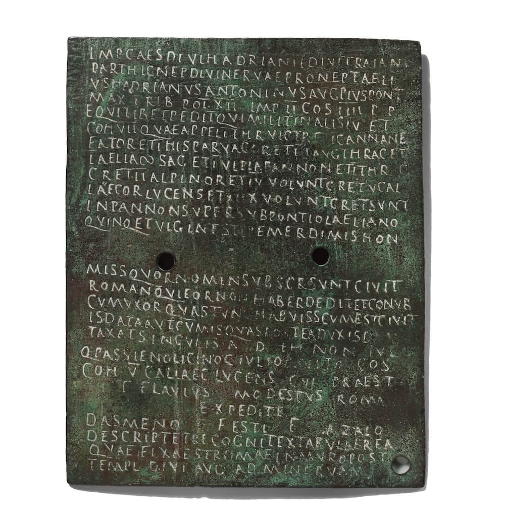 A bronze plate covered in Latin text.