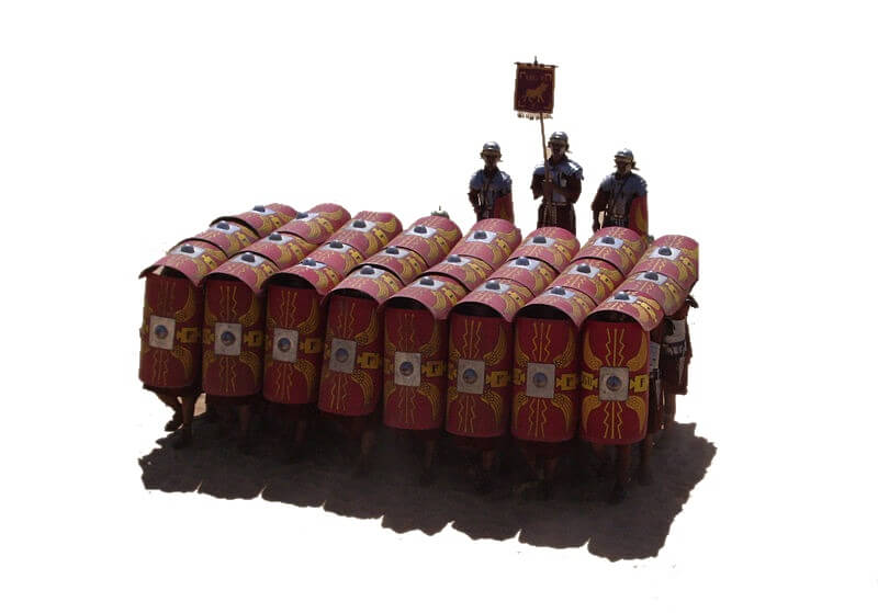 A tortoise formation. The front rank hold their large, curved, red shields in front of them, while the ranks behind hold their shields over their heads. Almost no gaps are visible.